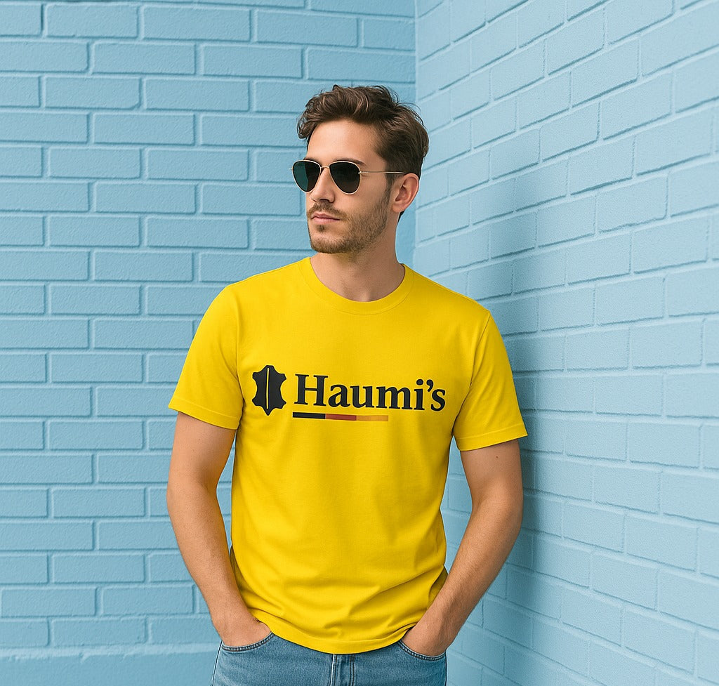 Stylish yellow t-shirt with the text 'Haumi's' in bold black font, designed by HAUMIS, shown in a casual setting.
