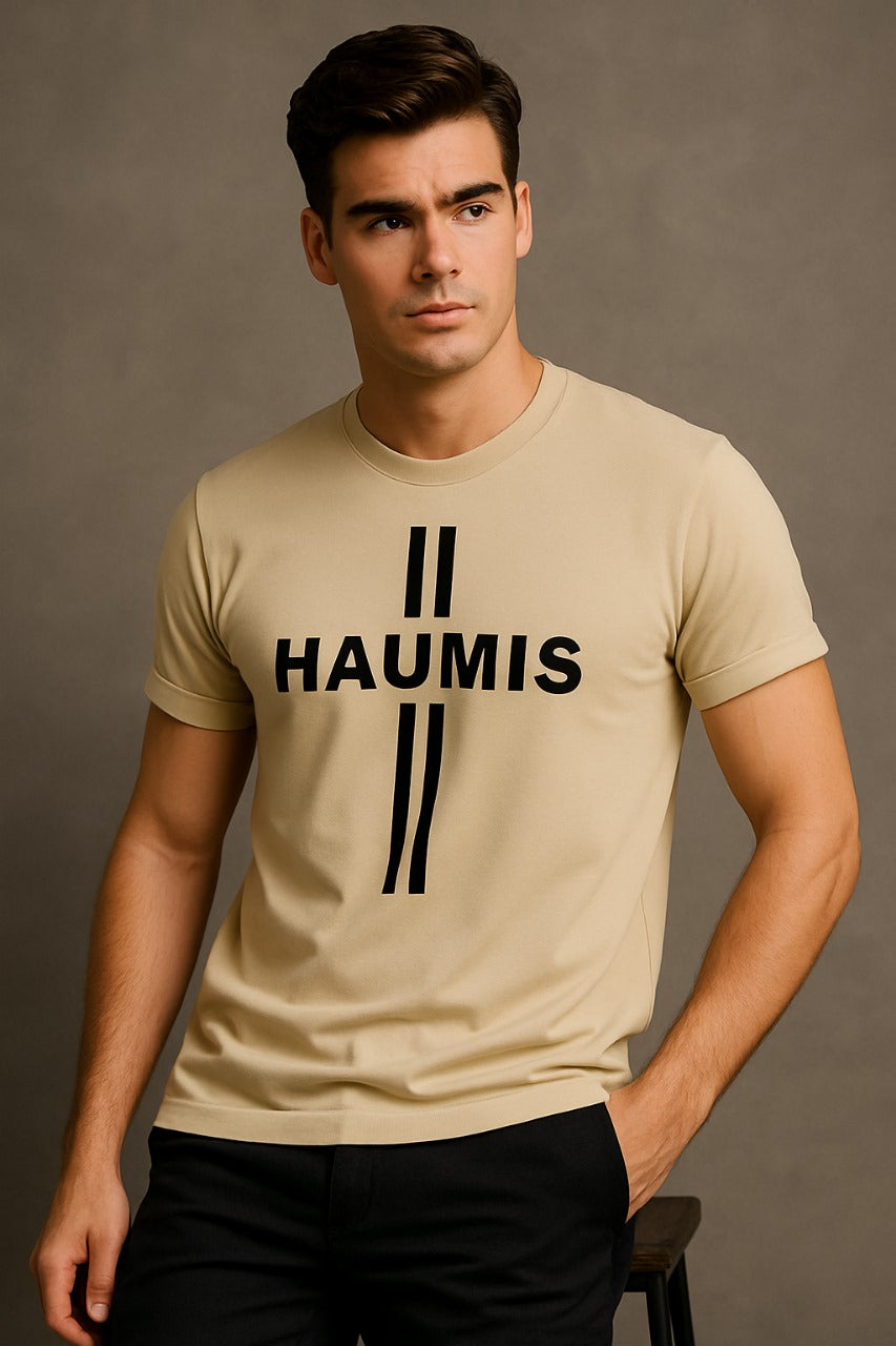 Model wearing HAUMIS Sand Stripe T-Shirt in Sand Beige with bold black typography, showcasing a relaxed fit and minimalist design.