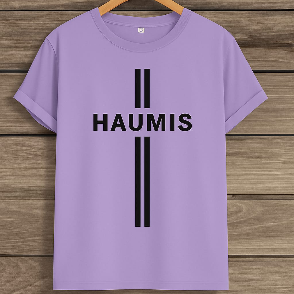 HAUMIS Sand Stripe T-Shirt in lavender color displayed on a wooden background, featuring bold black lettering and relaxed fit.