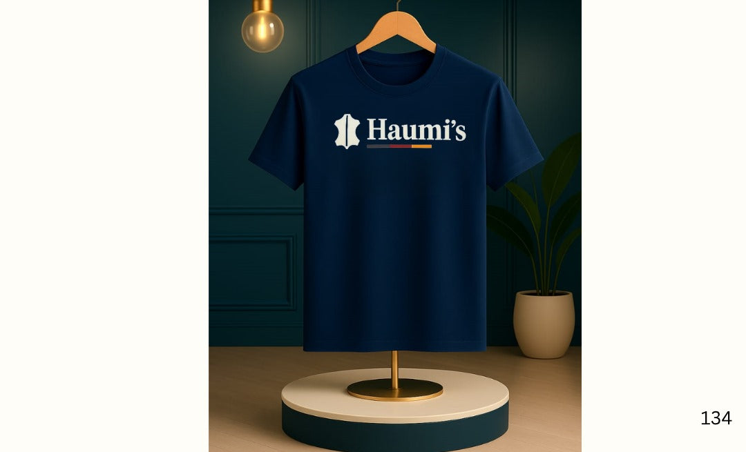 Haumi's Emblem Tee – Earthline Edition in Navy color, presented on a stylish wooden hanger, highlighting the iconic emblem and clean fit.