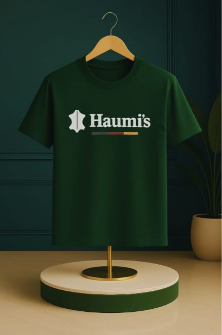 Haumi's Emblem Tee – Earthline Edition in Forest Green color, stylishly presented on a wooden hanger, highlighting a minimalist look with the emblem.