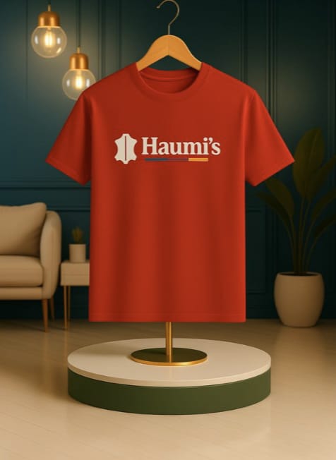 Haumi's Emblem Tee – Earthline Edition in Red, elegantly shown on a wooden hanger, featuring the Haumi's logo and a fresh, casual style.